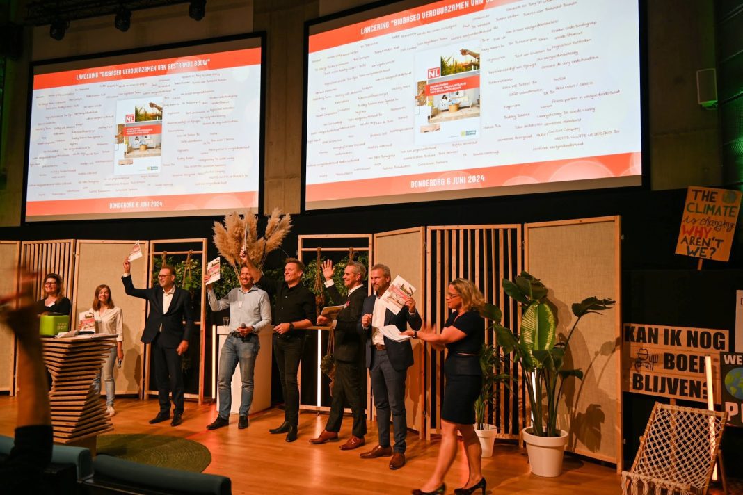 Betrokkenen tonen trots de handleiding aan het publiek.